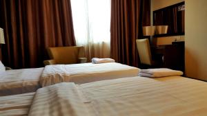 Ένα ή περισσότερα κρεβάτια σε δωμάτιο στο Lintas View Hotel