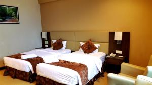 Ένα ή περισσότερα κρεβάτια σε δωμάτιο στο Lintas View Hotel