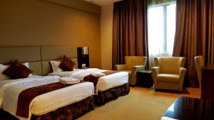 Postel nebo postele na pokoji v ubytování Lintas View Hotel