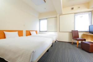 A bed or beds in a room at FLEXSTAY INN Sugamo