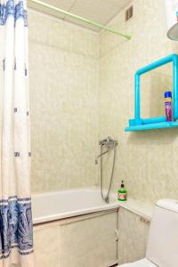 a bathroom with a shower and a tub and a toilet at Apartment TwoPillows on Lenina 56 in Vorkuta