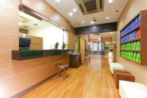 an office lobby with a bar and a chair at FLEXSTAY INN Sugamo in Tokyo