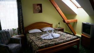 a bedroom with a bed with a basket on it at Hotel Tukums in Tukums