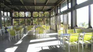 a room with yellow chairs and tables and windows at Yulan Green Roof in Datong