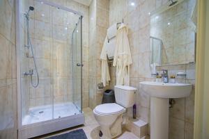 a bathroom with a toilet and a shower and a sink at Hotel X.O in Novosibirsk