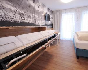 a room with a bed and a couch and a tv at Gästehaus zur Krone in Niedersonthofen +22 photos