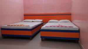 two beds sitting next to each other in a room at Hotel Utsav & Marriage Hall in Gaya