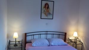 een slaapkamer met een bed met een schilderij aan de muur bij Apartment Leonardo in Medulin +66 foto's