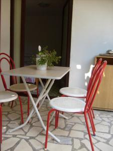 a table and chairs with a potted plant on it at Vila Veronika in Ohrid