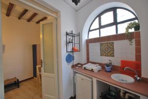 a bathroom with a sink and a window at Vulcanoconsult Appartamenti Spiaggia in Lipari