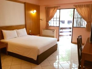 a hotel room with a bed and a balcony at Pattaya At Nine in Pattaya Central