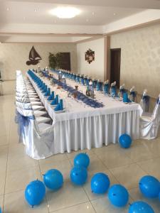 a long table with blue chairs in a room at Penzión Anima in Kaluža