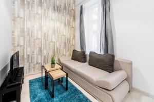 a living room with a couch and a window at Barcsay Apartment in Budapest