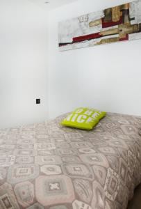 a bed with a yellow pillow on top of it at MY CASA - 48 GIOFFREDO - NEAR PLACE MASSENA in Nice