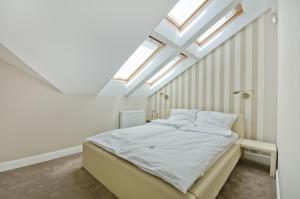 a bedroom with a bed with skylights at Imperial Apartments - Nautica in Sopot