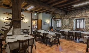 a restaurant with tables and chairs in a room at Casa rural Restaurante Aranburu in Zestoa