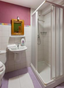 a bathroom with a shower and a sink and a toilet at Casa rural Restaurante Aranburu in Zestoa +26 photos