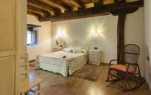 a bedroom with a white bed and a chair at Casa rural Restaurante Aranburu in Zestoa