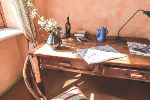a wooden desk with a vase on top of it at Cascina Lissona in Asti