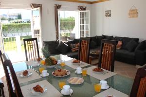 a dining room with a table with food on it at Villa Summertime - Private Jacuzzi and bikes, beach 800m in Albufeira