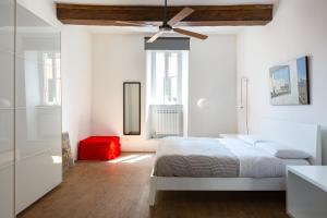 ローマにあるVicoloft Vicoloの白いベッドルーム(ベッド1台、天井ファン付)