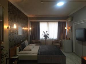 a bedroom with a large bed and a television at Masal Otel in Kocaeli