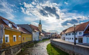 a street in a town with buildings and a church at Apartman Rudi in Samobor