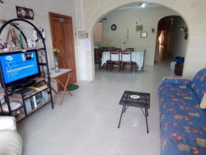 a living room with a couch and a table at Coral Reef Flat 7 in Marsalforn