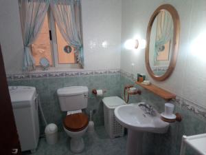a bathroom with a toilet and a sink and a mirror at Coral Reef Flat 7 in Marsalforn +14 photos