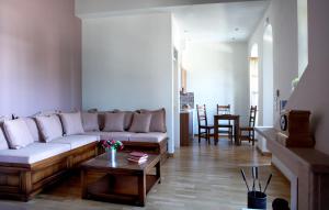 a living room with a couch and a coffee table at Ilakia in Tholón +22 photos