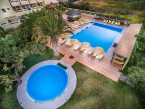 an overhead view of a swimming pool in a backyard at Tylissos Beach Hotel - Adults Only in Ierápetra