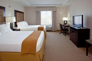a hotel room with two beds and a flat screen tv at Holiday Inn Express Texas City, an IHG Hotel in Texas City