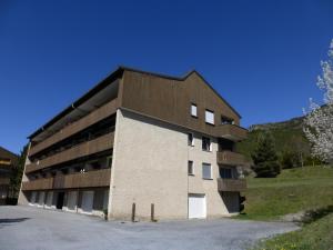 a largeartment building with a parking lot in front of it at Chalanche in Barcelonnette