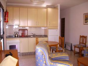 a kitchen with a couch and a table in a room at El Capistrano Sur in Nerja