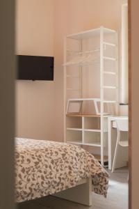 a bedroom with a bunk bed and a desk at Nonna Anna Rooms in Palermo