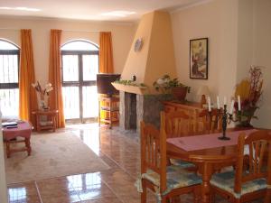 a living room with a table and a fireplace at El Capistrano Sur in Nerja