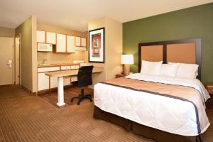 a hotel room with a bed and a desk at Extended Stay America Select Suites - Denver - Tech Center South in Centennial