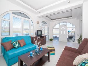 a living room with a blue couch and a table at Apartments Elena in Tivat