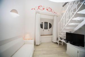 a white room with a staircase and a window at La Settima Luna Hotel in Canneto