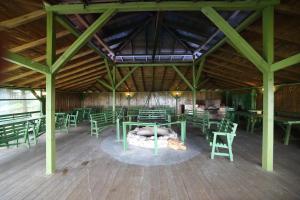 a room with green tables and chairs in a building at Rezydencja Legrams in Darłowo
