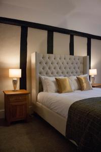 a large bed in a hotel room with two lamps at The Swan Hotel Bar and Grill in Maldon