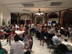 a large group of people sitting at tables in a room at Château de la Grange Fort in Issoire