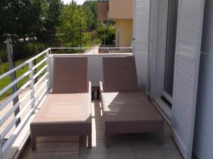 two benches sitting on the balcony of a house at Marine House Andrianna -Adults only in Siviri