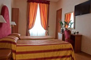 a hotel room with a bed and a window at Hotel Brignole in Genoa