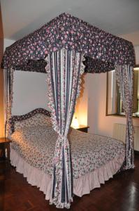 a bedroom with a canopy bed with a canopyilt at B&B Da Lucia in Fabriano