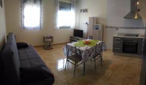 a living room with a table and a couch at Apartamento fuerte in Puerto del Rosario