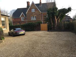 a car parked in a driveway in front of a house at The Old Rectory in King's Lynn