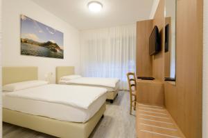 Postel nebo postele na pokoji v ubytování Hotel Ceresio + 32 fotografií