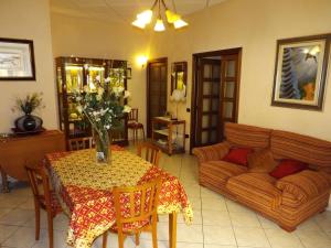 a living room with a table and a couch at B&B Le Grazie in Siniscola