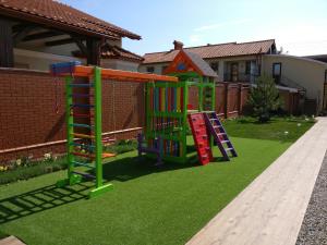 two playground equipment on grass in front of a house at Kosmos 519 in Zatoka